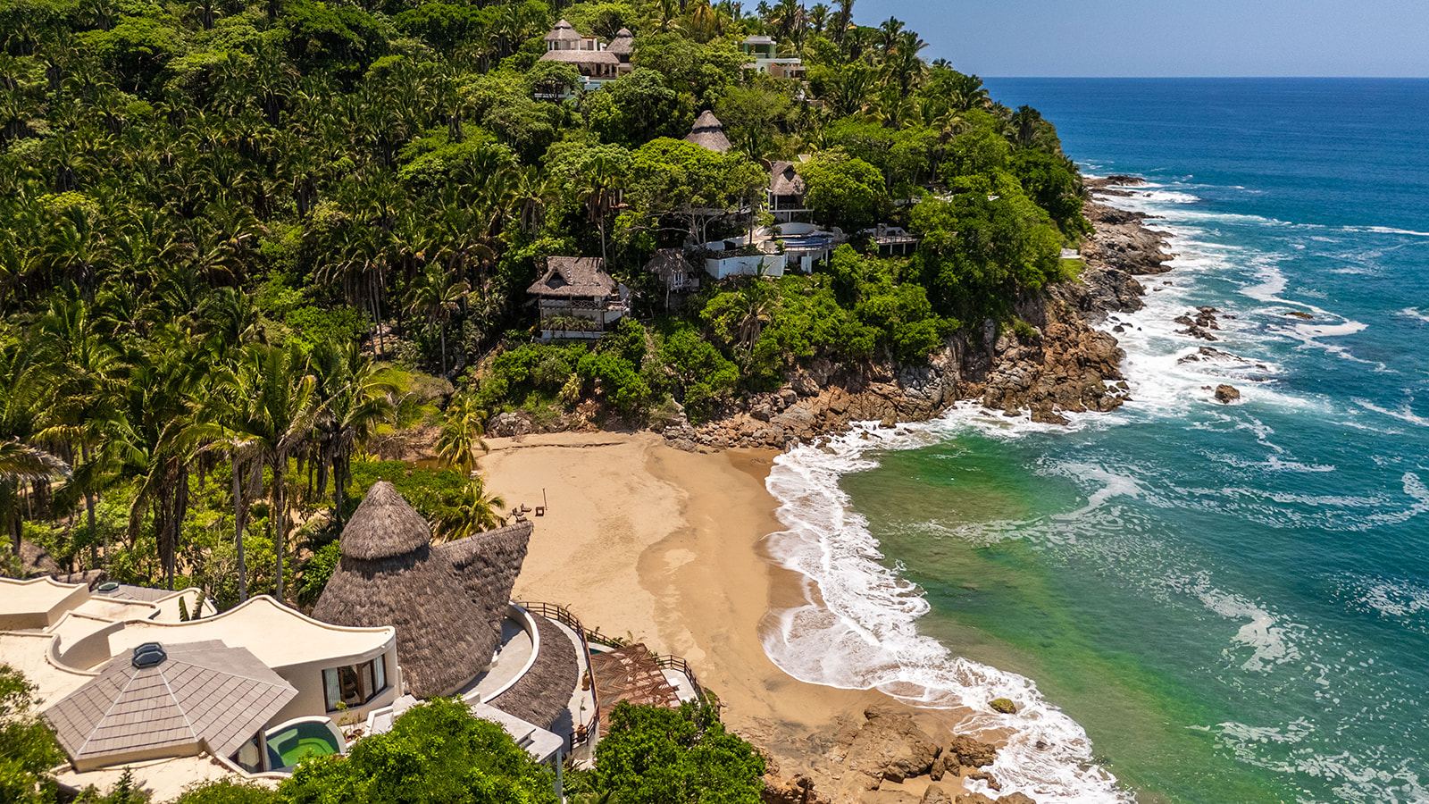 Aerial view of the cove with both villas in the jungle