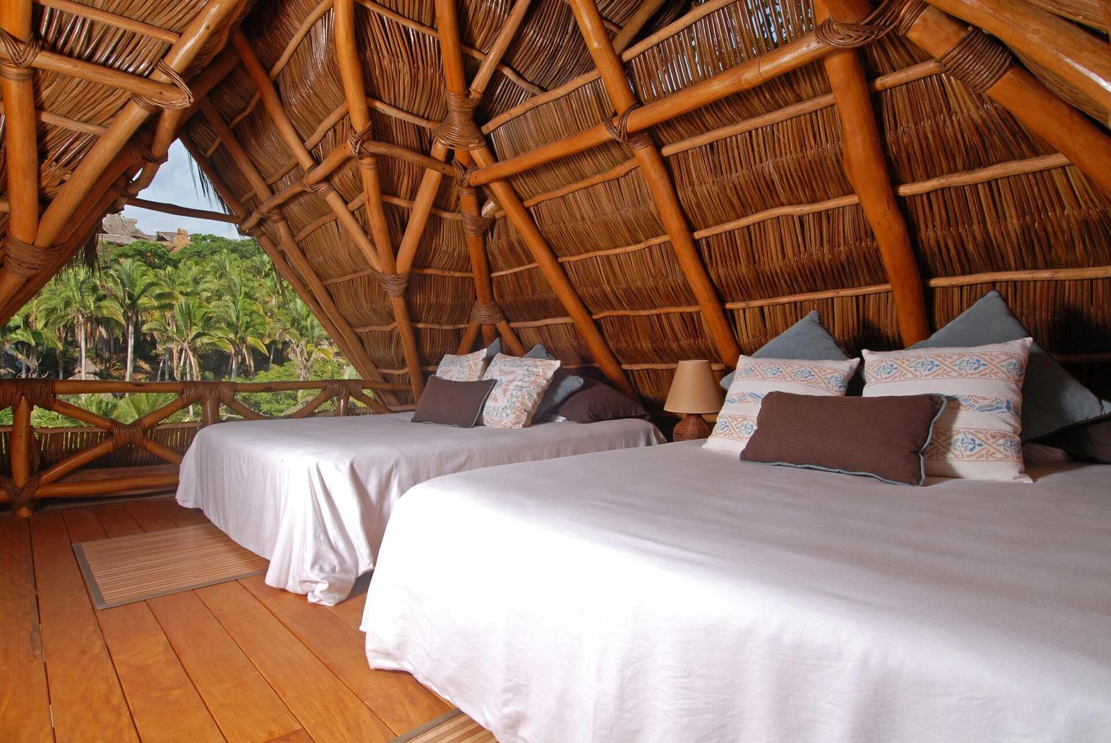 Bedroom under the palm roof at Villa Violeta
